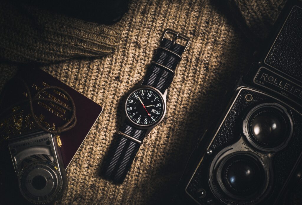 A black watch in the centre of a flat-lay image. First image to demonstrate a guide to watch cleaning. 