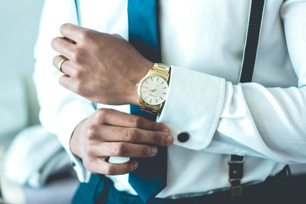An image of a white and gold watch on a mans wrist. An image to accompany our guide on how to save money when buying a watch.