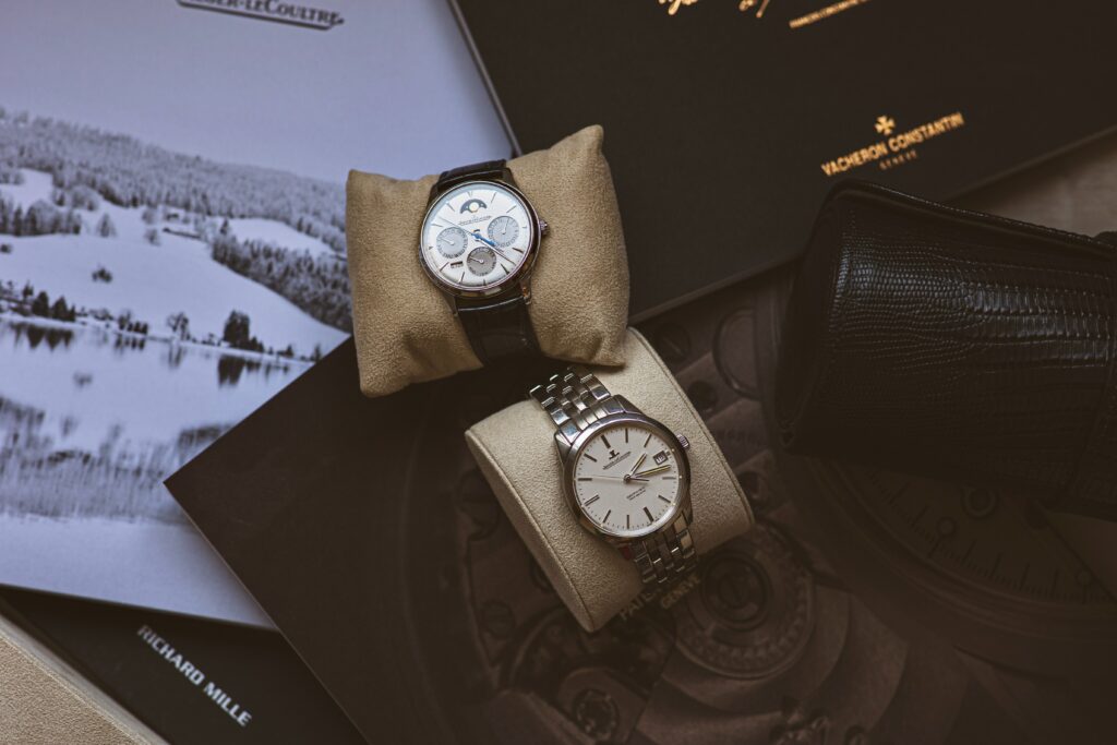 Aerial view of two watches still in packaging. This is our guide to finding pre-owned watches for sale.